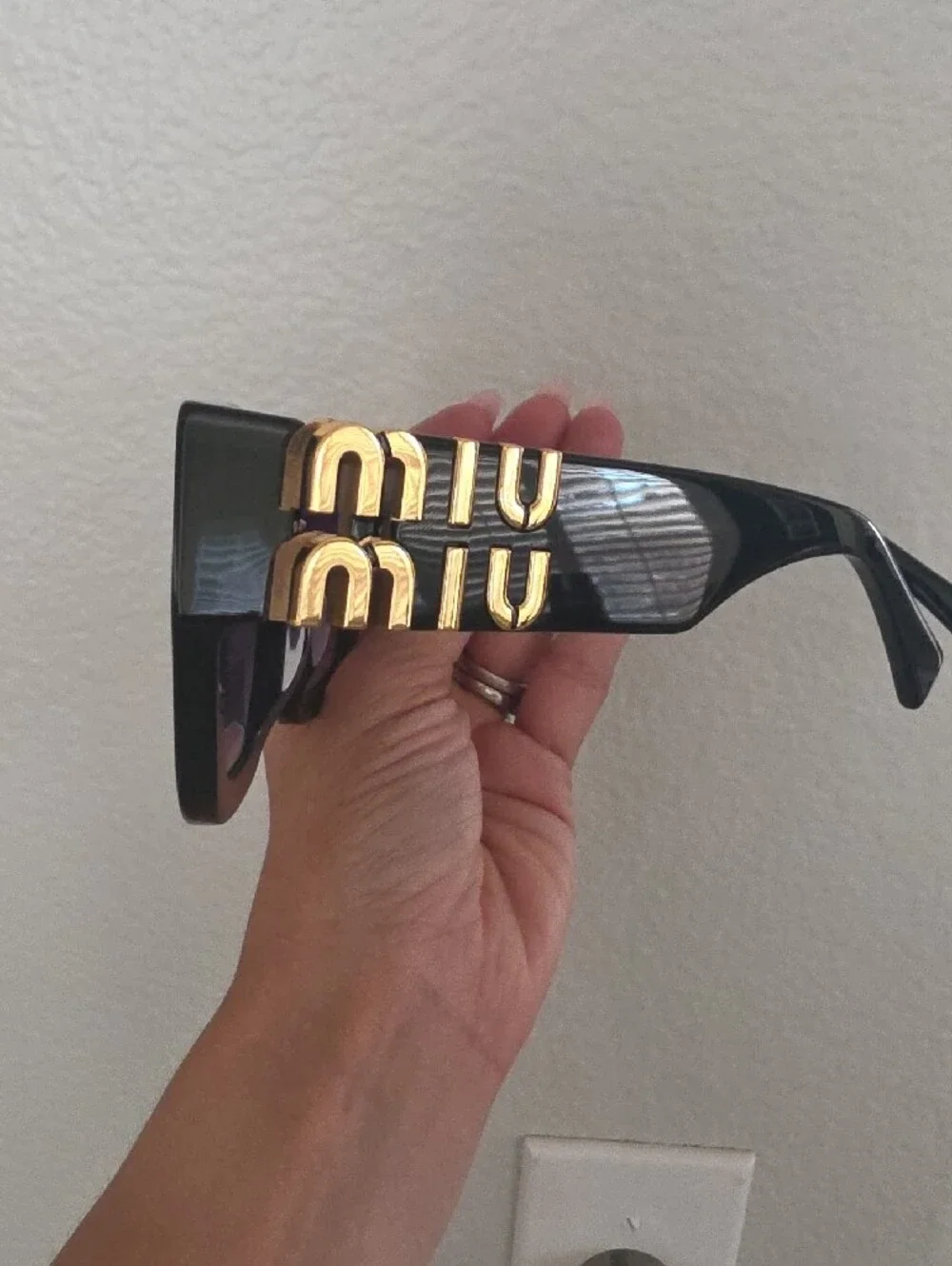 Miu Miu Glossy Black Frame Sunglasses with Purple Lenses